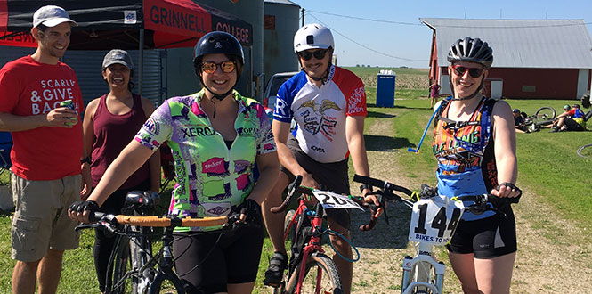 Dan Covino ’10, far left, and Vrinda Varia were among the volunteers helping with the Grinnell group project during the Prairie Burn 100 bicycle ride.